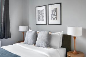 a bedroom with a white couch and two lamps at East Village 1br w doorman wd nr Union Square NYC-1153 in New York