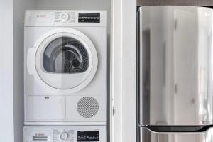 a washing machine sitting next to a refrigerator at East Village 1br w doorman wd nr Union Square NYC-1153 in New York