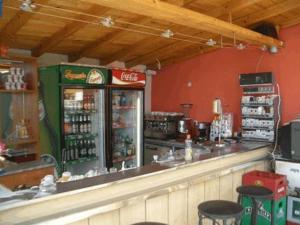 a bar in a restaurant with a coca cola machine at Hotel Poseidon in Golden Sands