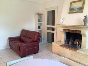a living room with a chair and a fireplace at Gîte T1 bis,40 m2 in Molières