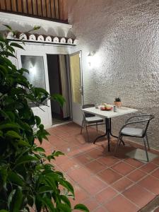a patio with a table and chairs on a tile floor at Lovely studio Nerja ground floor in Nerja