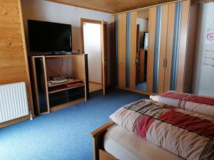 a hotel room with a bed and a flat screen tv at Ferienwohnung Ingrid in Radmer an der Hasel