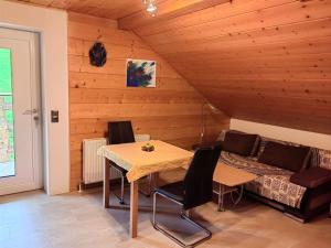 a dining room with a table and a couch at Ferienwohnung Ingrid in Radmer an der Hasel