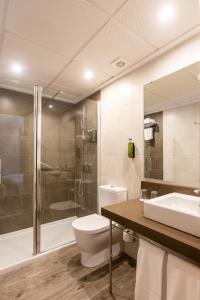 a bathroom with a toilet and a shower and a sink at Ona Palmira Paguera in Paguera