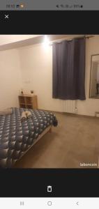 um quarto com uma cama e uma cortina preta em Jolie T2 en rez de chaussée em Carcassonne