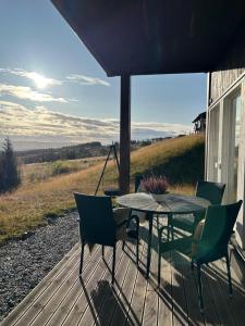 a patio with a table and chairs on a deck at Bualie Golsfjellet in Gol