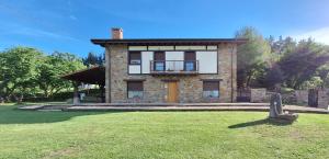 una gran casa de ladrillo con un patio delante en Casa Rural Launtzin Landetxea en Areatza