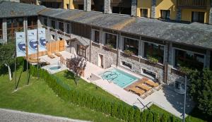 an aerial view of a building with a swimming pool at Blu Hotel Acquaseria in Ponte di Legno