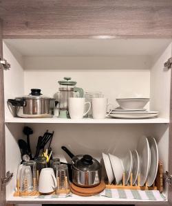 a shelf with dishes and utensils in a kitchen at SMDC Coast Residences in Manila