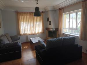 a living room with two couches and a table at Casa Peña Sierra de Francia in Aldeanueva de la Sierra