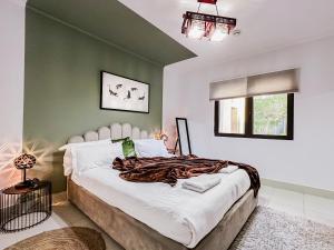 a bedroom with a large bed and a green wall at Trophy - Burj Khalifa View Serenity Suite in Dubai
