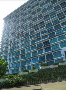 a large apartment building with windows and plants at Oceanfront Condos Galle-Apartment L410 A in Galle