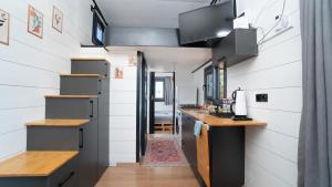 a tiny house with a kitchen and a hallway at Olive Garden Tiny House in Kumluca