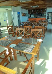 a dining room with wooden tables and wooden chairs at Oceanfront Condos Galle-Apartment L410 A in Galle