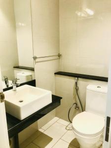 a bathroom with a white toilet and a sink at Oceanfront Condos Galle-Apartment L410 A in Galle