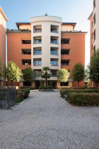 a large apartment building with a walkway in front of it at Bella Ciao Airport Apartment in Seriate