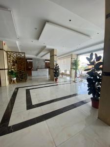a lobby with a large room with plants in it at فندق اجنحة السمو بجازان in Jazan