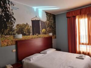 a bedroom with a bed with a large wooden headboard at Città Della Notte in Augusta