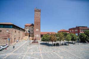 a large parking lot with a tall brick tower at Bilocale Centralissimo in Leinì