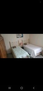 two beds sitting next to each other in a bedroom at Home away from home in Mildenhall