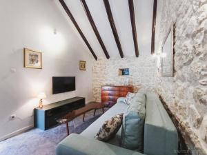 a living room with a couch and a tv at Didini Dvori in Kruševo