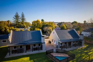 an aerial view of a house with a blue roof at Dolittle Cottages in Swellendam
