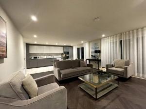 a living room with two couches and a table at 2BR Urban Vista Retreat CHCL F7 in Chigwell