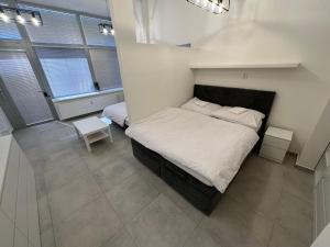 a bedroom with a large bed with white sheets at Krásny byt - veľký apartmán v blízkosti centra in Bratislava