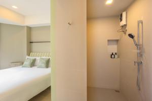 Postel nebo postele na pokoji v ubytování Chamemon Bed Phuket Town