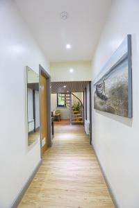 a hallway of a house with paintings on the walls at A104 Bright Modern Loft in Coventry