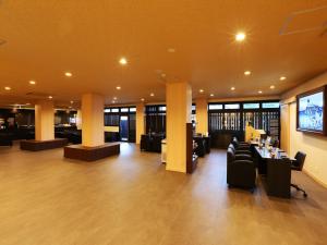 a lobby with couches and tables in a building at Arima Royal Hotel in Kobe