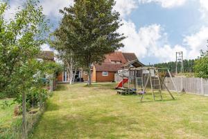 a yard with a playground with a swing at Worth Cottage - Perfect for families & friends in Worth