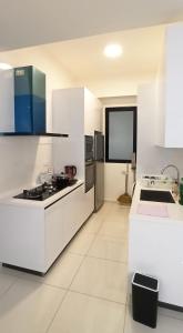 a white kitchen with a sink and a stove at Beacon Executive Suites George Town Apartment Malaysia deals in George Town