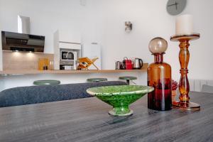 a table with a bottle and a bowl on it at Sublime T4 coeur de ville Jaurès in Limoges
