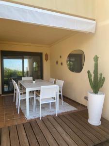 ein Esszimmer mit einem weißen Tisch und einem Kaktus in der Unterkunft Los Piños, 2 Bedroom Apartment with panoramic view in Benahavís