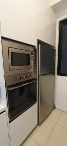 a kitchen with a microwave and a refrigerator at Beacon Executive Suites George Town Apartment Malaysia deals in George Town +8 photos