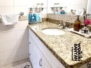 a bathroom with a sink and a counter top at Stunning 1BD a block away to Waikiki Beach Free Parking in Honolulu