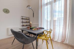 a dining room with a table and two chairs at Sublime T4 coeur de ville Jaurès in Limoges