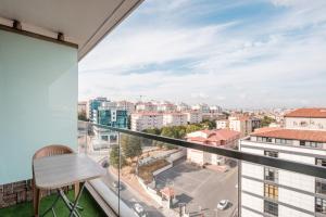 a balcony with a desk and a view of a city at Studio with City View Balcony 2 min to Metro in Istanbul