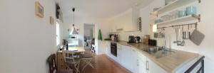 a kitchen with a sink and a counter top at Casa 1659 - Casa Parrucchiere in Gandria