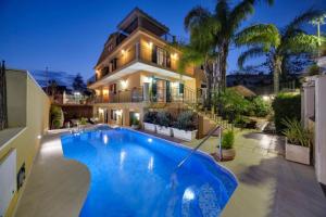 a house with a large swimming pool in front of it at Villa Magda - private pool 22 pax in Marina di Ragusa