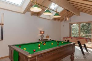 a room with a pool table with balls on it at Chalet Le Pourquoi Pas in La Bresse