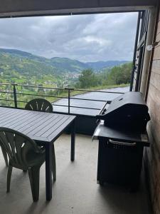 a printer sitting on a table on a balcony at LE MASSIF - Appartement avec vue imprenable in La Bresse