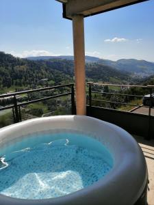 a hot tub on a balcony with a view at LE MASSIF - Appartement avec vue imprenable in La Bresse