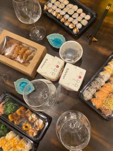 a table topped with trays of food and wine glasses at Fifi Home in Pozzuoli