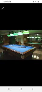 a pool table sitting in a room with lights at Residence PARADISO in Roccaraso