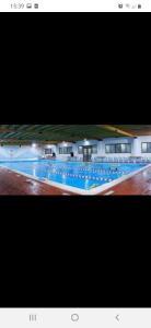 two photographs of a large swimming pool at night at Residence PARADISO in Roccaraso