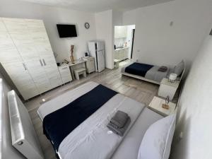 a large white bedroom with a bed and a sink at La Luna Imobiliare in Ocna-Mureşului