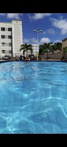 a large pool of blue water in front of a building at Apt da Leily in São Luís