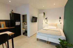 a bedroom with a bed and a bathroom at Goldstadt Apartments in Pforzheim